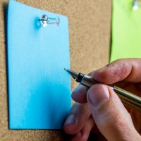 Writing on blue post it paper